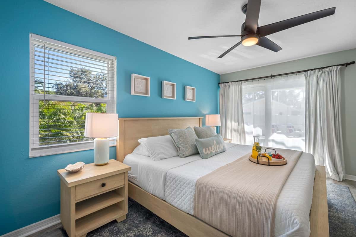 The elegant king bedroom offers a relaxing space with modern decor, a private ensuite, and plenty of natural light.