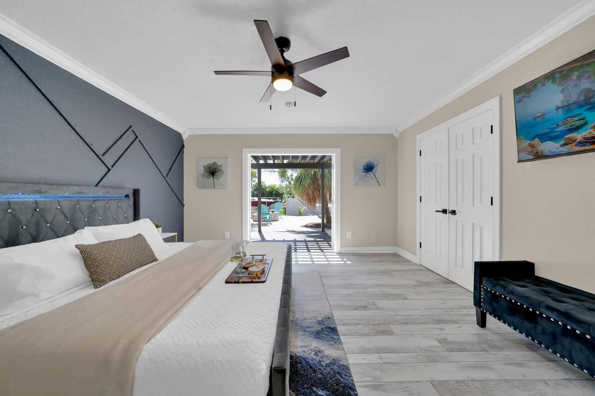 A tufted tan headboard and soft neutral tones make this second king suite feel like its own private getaway