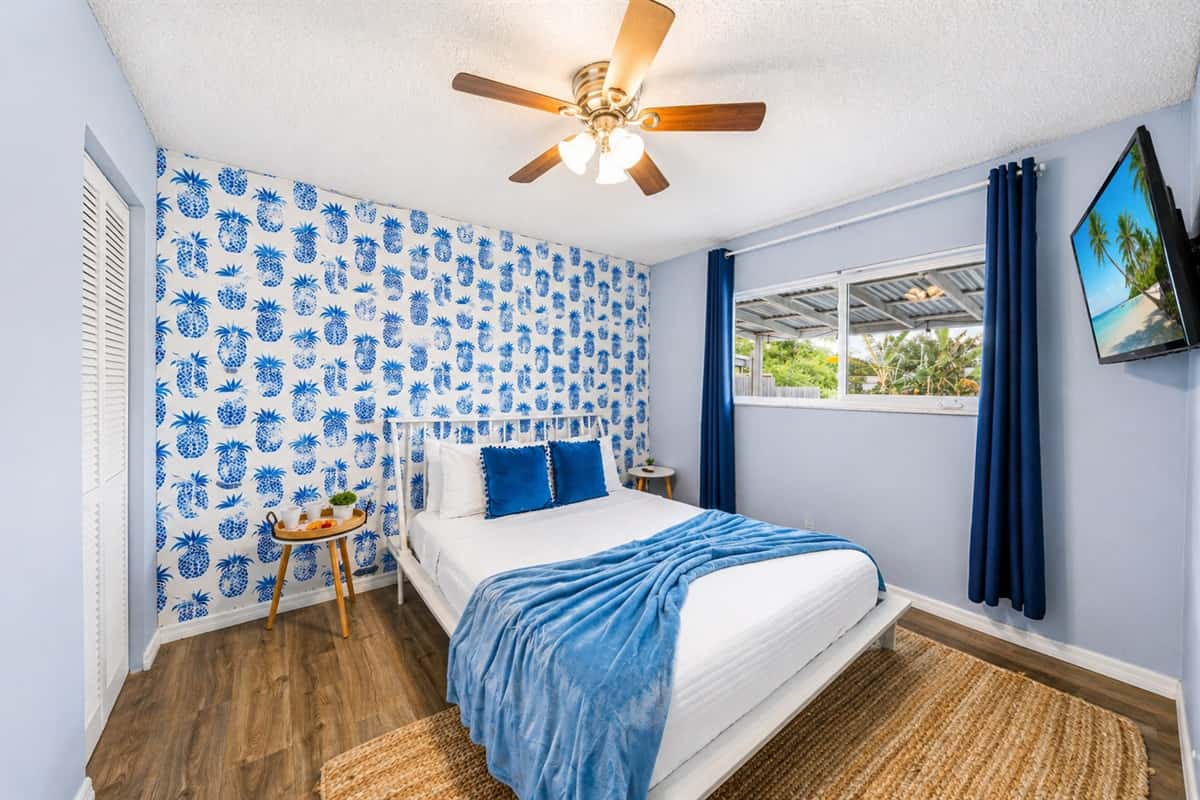 Bright Bedroom 3 featuring a comfortable king bed, bold coastal accents, and natural light.