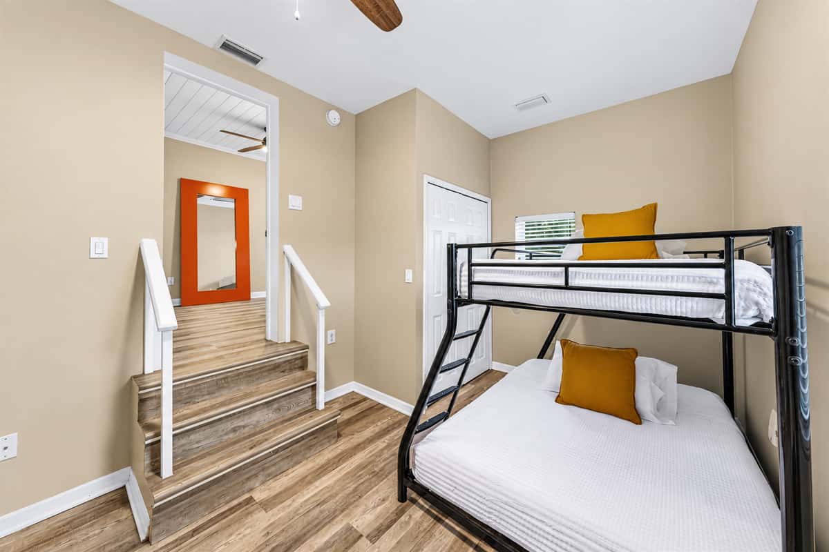 Bunk room with comfortable beds and nearby stair access—great for families or group stays.