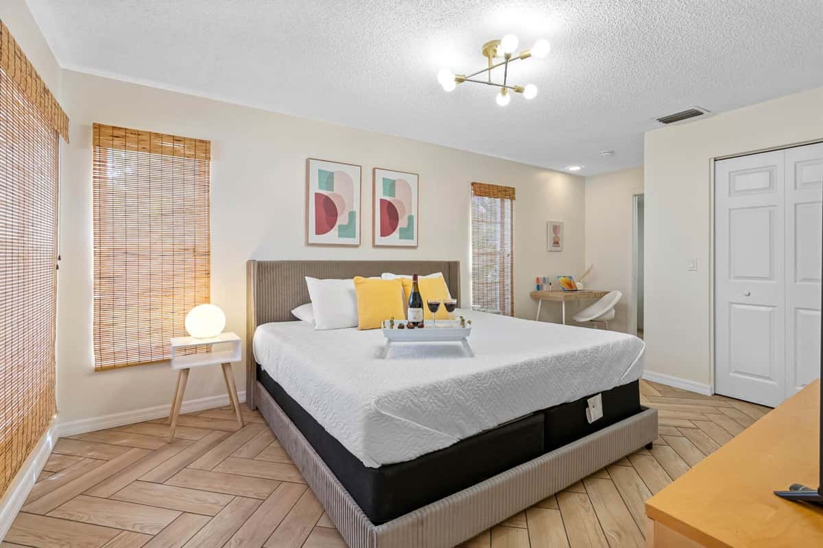Unwind in this calming master suite featuring a plush king-size bed, sleek furnishings, and warm natural light. Enjoy a peaceful night’s rest and direct access to a private ensuite bathroom.