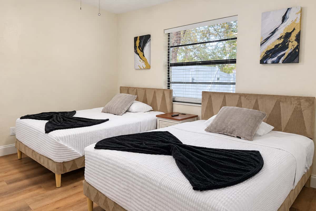 Bunk up with your favorite people. Two queen beds side by side, crisp white bedding and a window framed by green trees. Ideal for siblings, cousins or friends who want to keep talking after lights out.