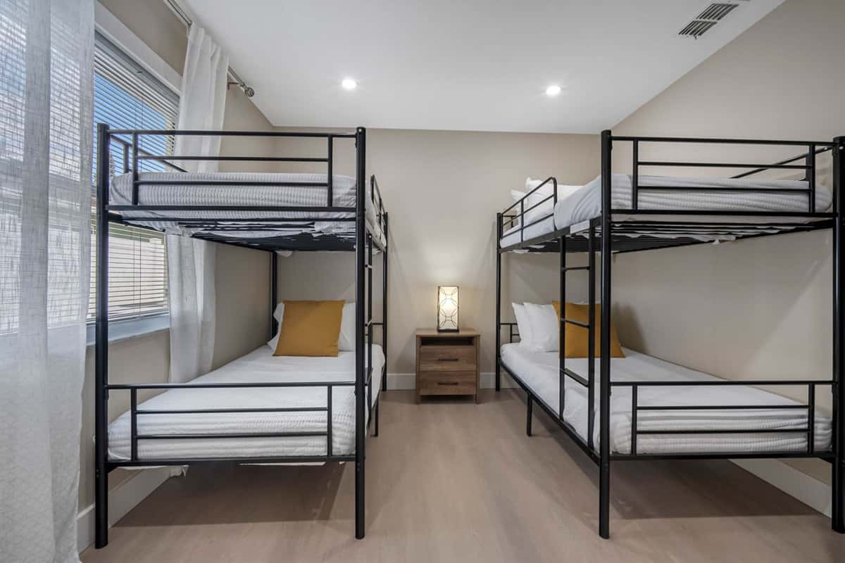 This bright and cheerful bedroom features two sleek bunk beds, offering cozy sleeping space for up to four guests — ideal for families or friends traveling together.
