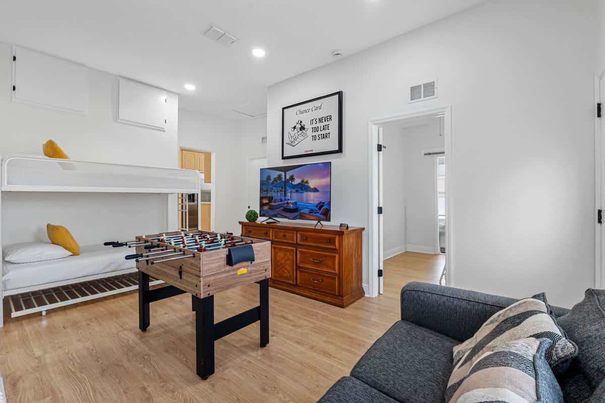 Designed for memorable evenings, this room includes a foosball table, cozy seating, and a flat-screen TV for movies, gaming, or friendly competition.