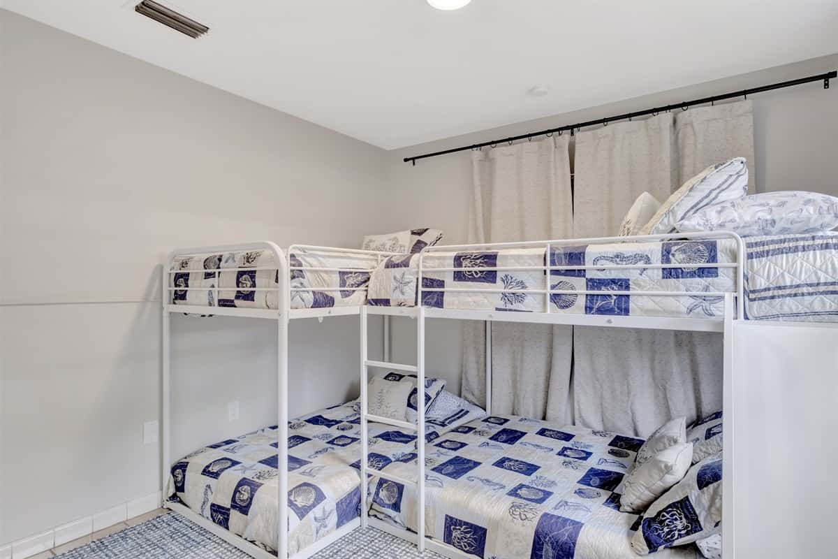 Our bedroom is a delightful space where imagination takes flight, featuring not one but two whimsical bunk beds that invite adventurous dreams.