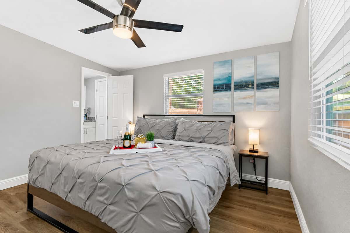 Flanking the bed are two beautifully crafted bedside tables, each adorned with a stunning lamp that emits a soft and warm glow.