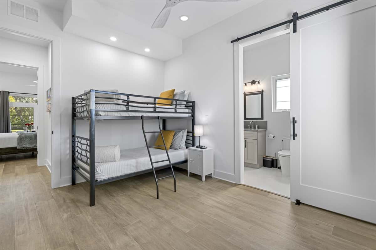 At the heart of this room is a beautifully crafted bunk bed, thoughtfully designed to maximize space while providing a fun and cozy sleeping arrangement.