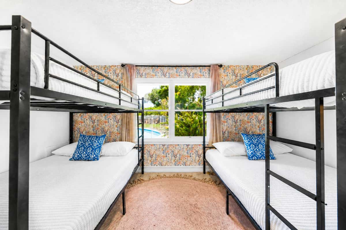 Real mattresses, real dresser, real closet space — bunk room, not an afterthought.