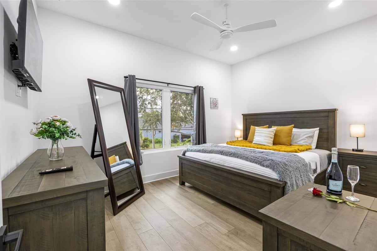 This bedroom is designed with a plush queen-sized bed, dressed in high-quality linens. The comfortable mattress is paired with soft, inviting pillows
