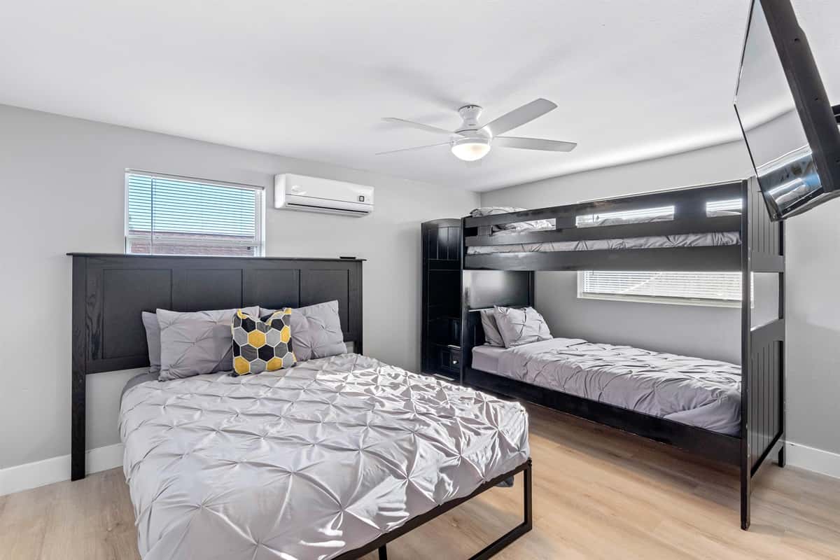 Beautiful bedroom with a bunkbed, queen sized bed, drawers for storage and smart TV. Ideal room for a family with kids or a group of friends.