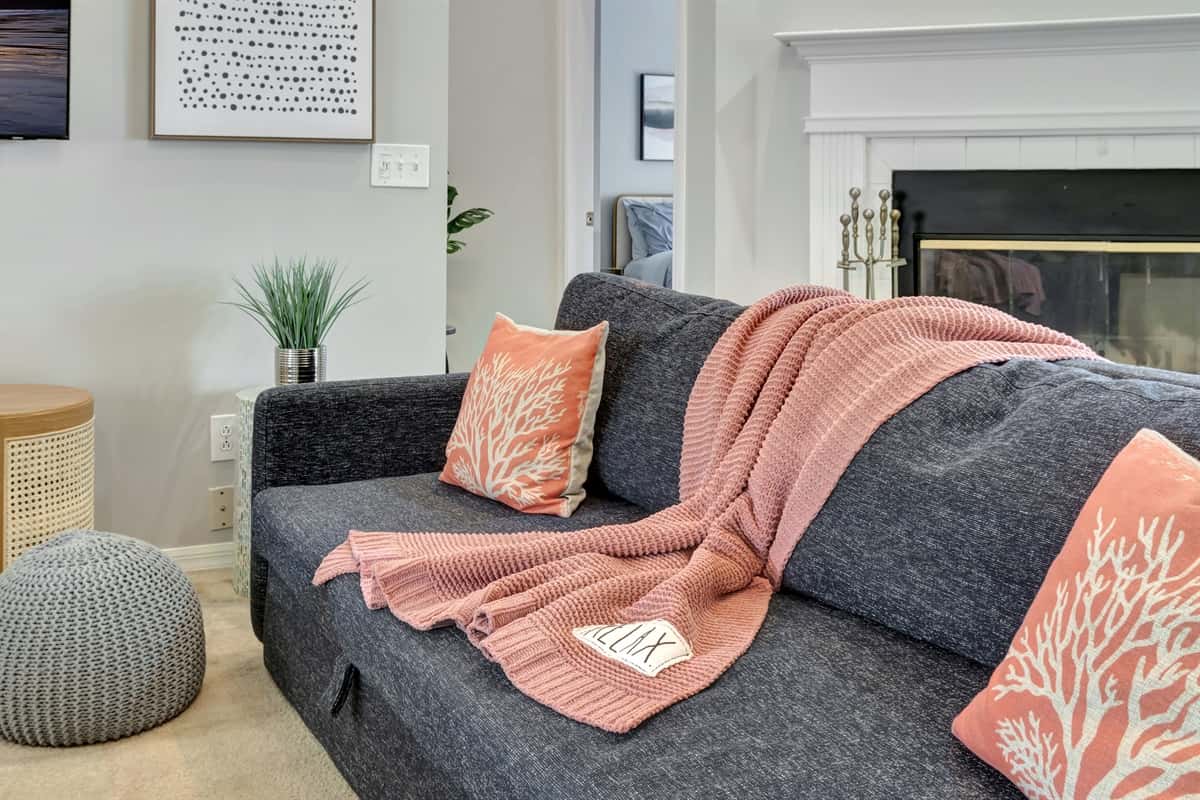 These delightful accents of the pastel-colored throw pillows  not only provide extra comfort but also infuse the space with a playful and inviting vibe.