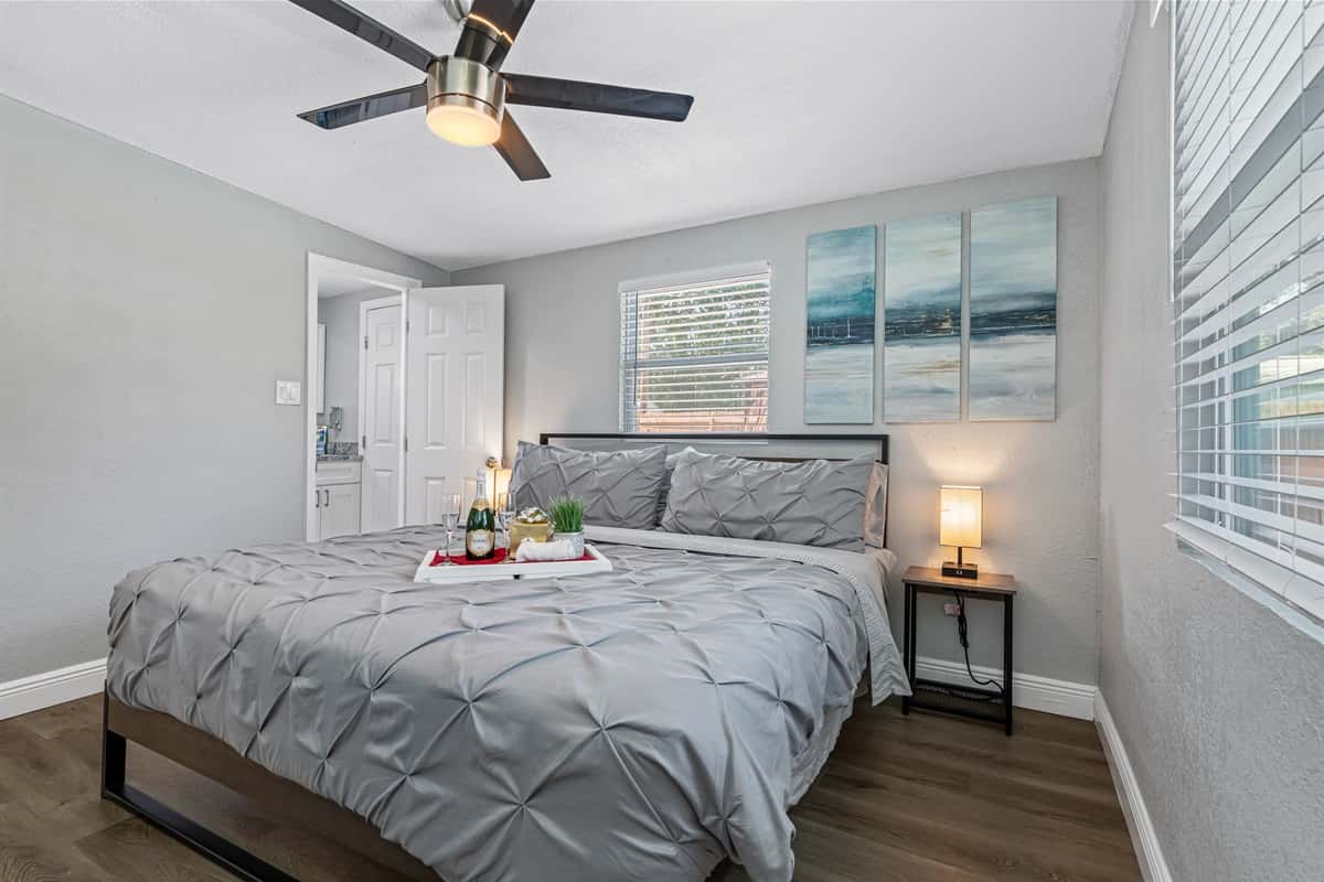 Flanking the bed are two beautifully crafted bedside tables, each adorned with a stunning lamp that emits a soft and warm glow.