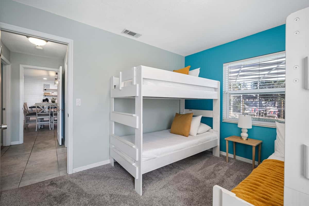 Perfect for kids or groups, this cheerful bunk room offers cozy twin-over-full beds and playful coastal colors.