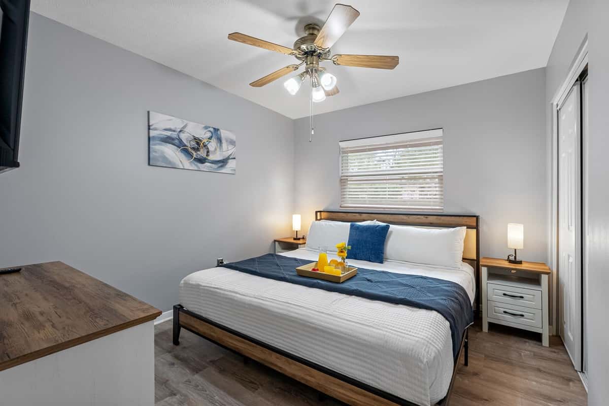Relax in this cozy king bedroom featuring plush bedding and calming neutral tones.