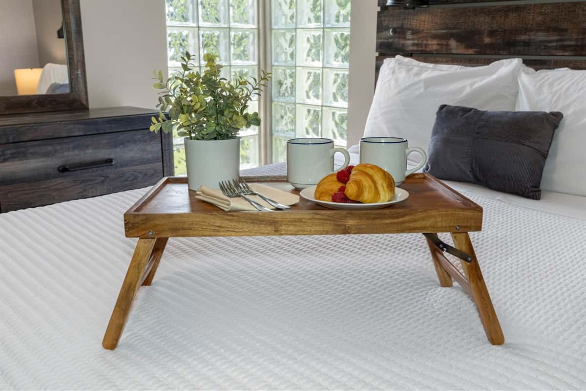 A blend of rustic wood finishes and sleek modern design creates a stylish yet comfortable bedroom retreat.