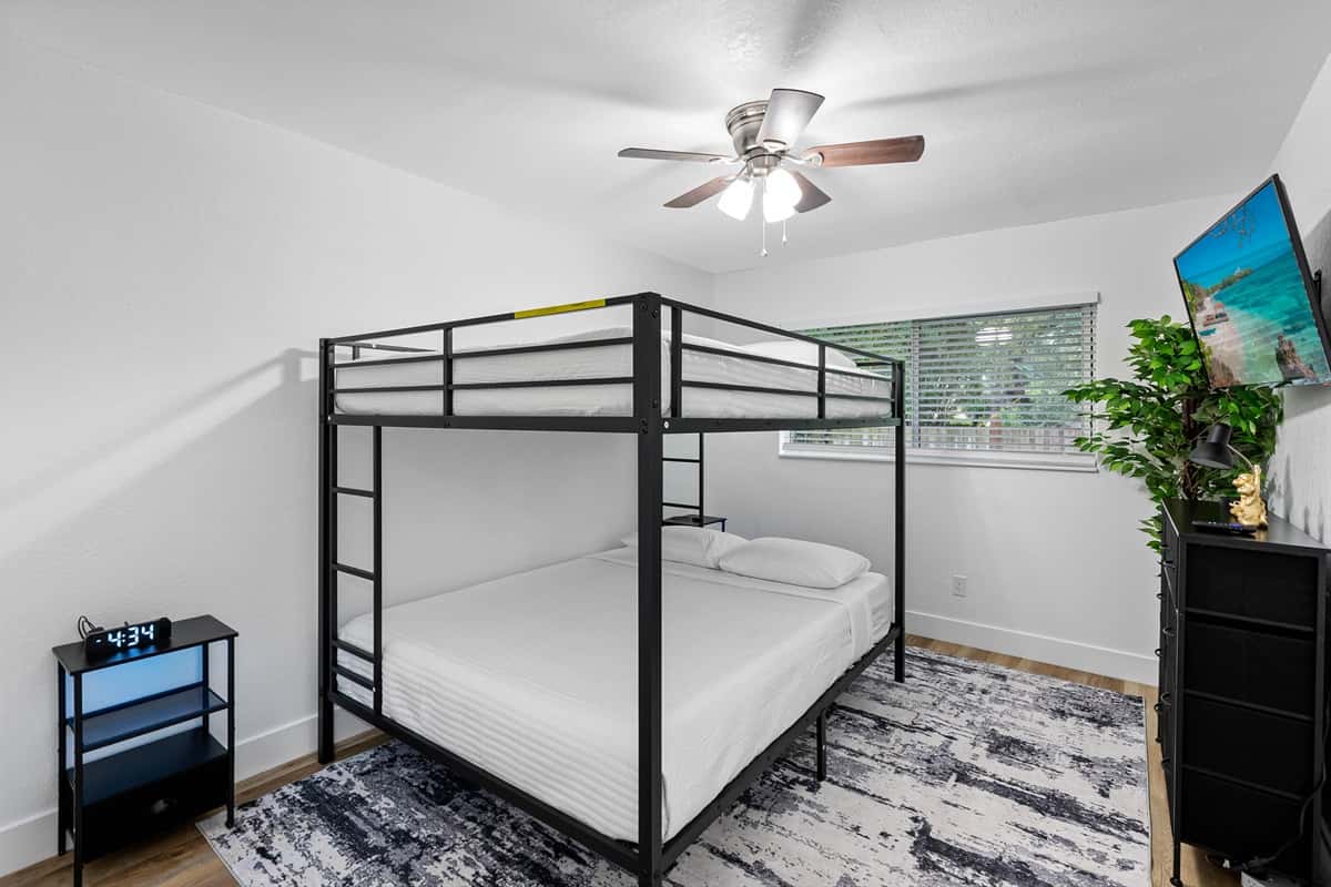 A dream setup for younger guests or travel buddies, this room features a sturdy metal bunk bed, warm textures, and a playful yet calming atmosphere.