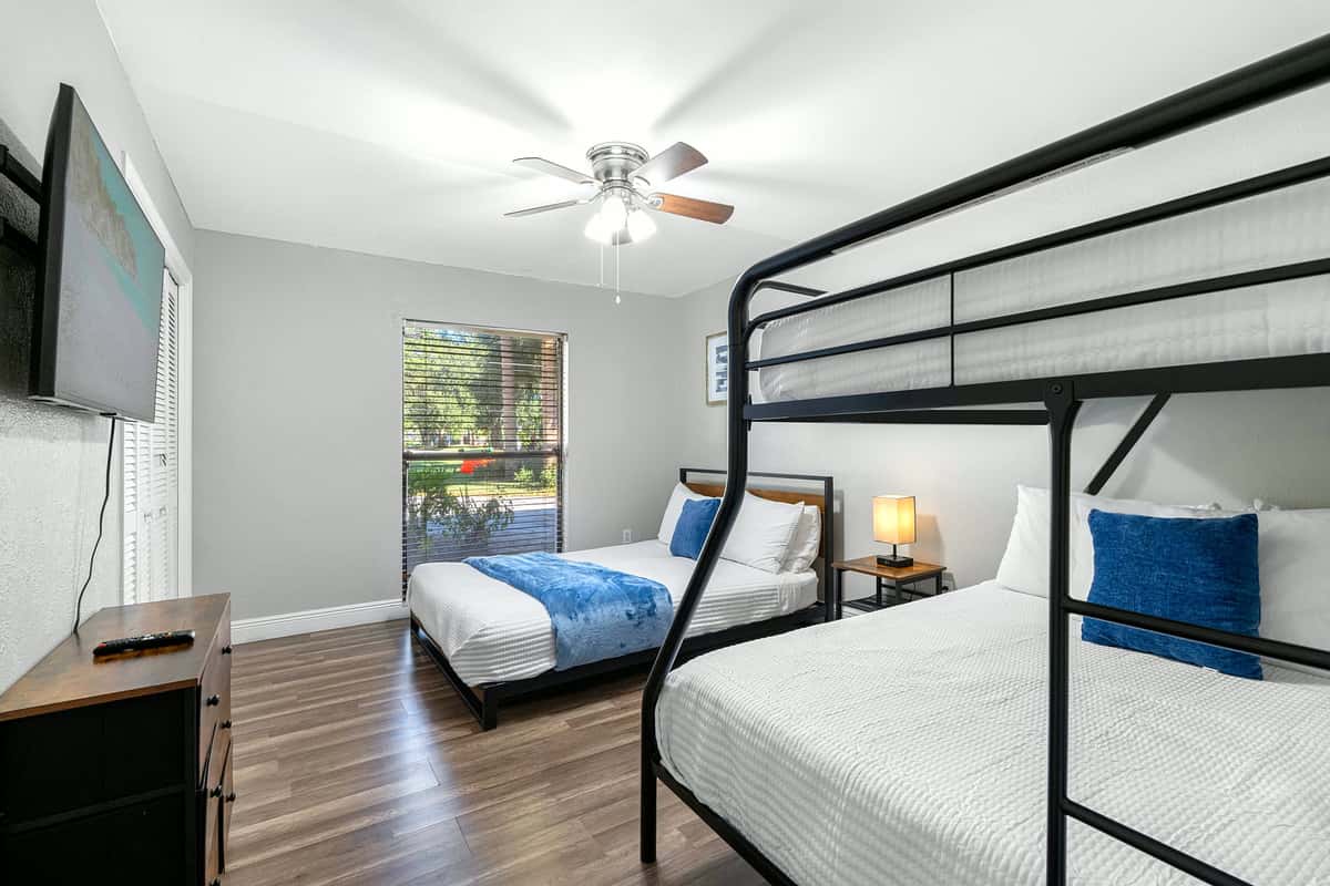 This cozy room offers a queen bed and bunk bed setup — ideal for kids or extra guests.