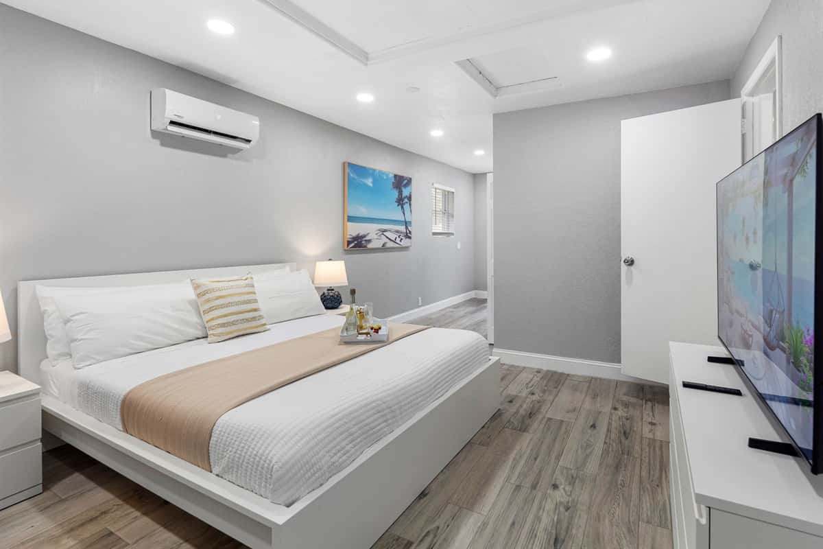 This peaceful bedroom is designed in soothing neutral tones, with sleek modern furnishings and soft ambient lighting for a truly relaxing stay.