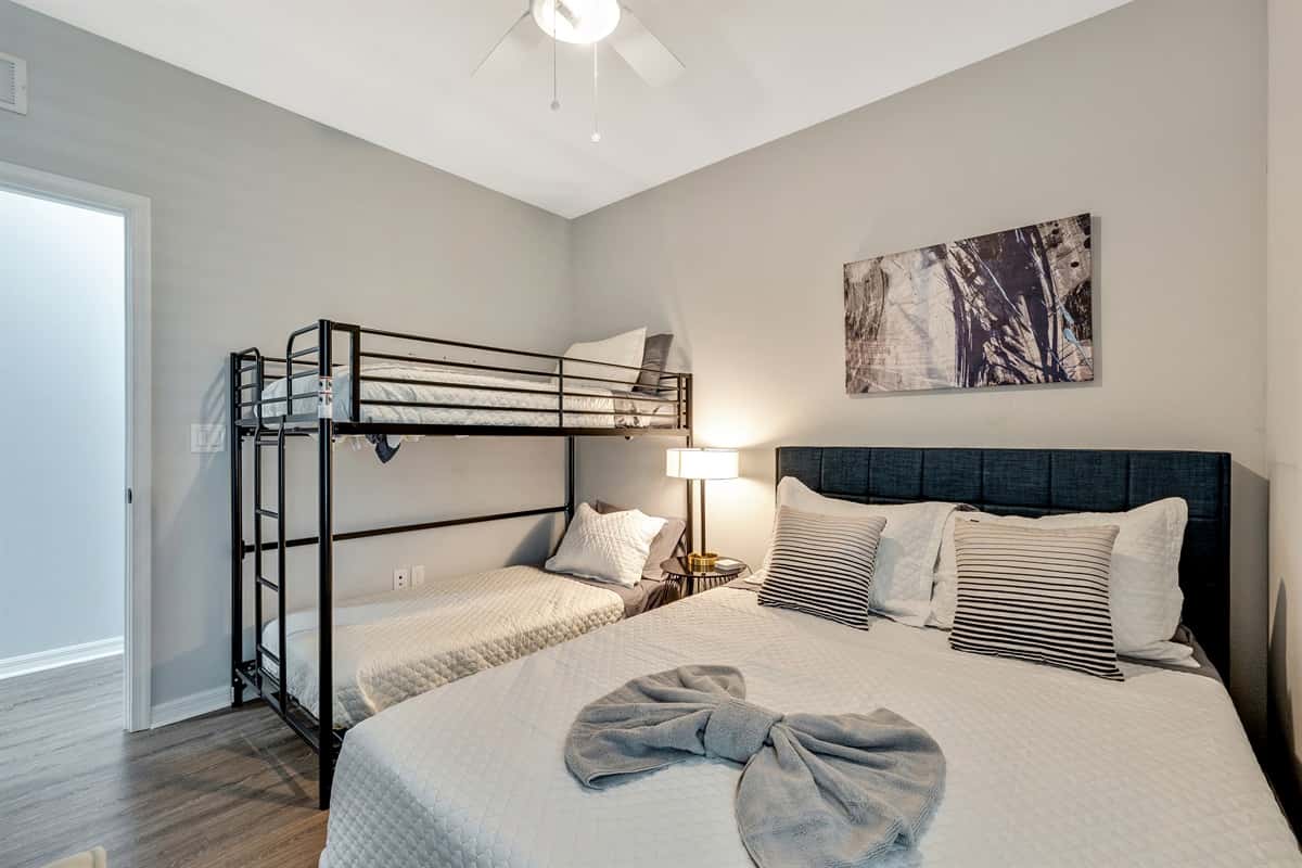 Adding an element of playful charm and practicality, the room features a captivating bunk bed, cleverly designed to accommodate a variety of needs.