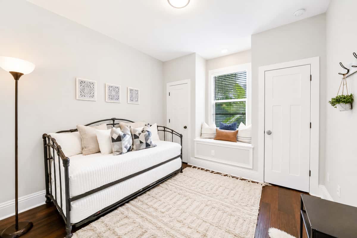 This bonus space features a cozy twin daybed and window nook, perfect for relaxing or accommodating an additional guest.