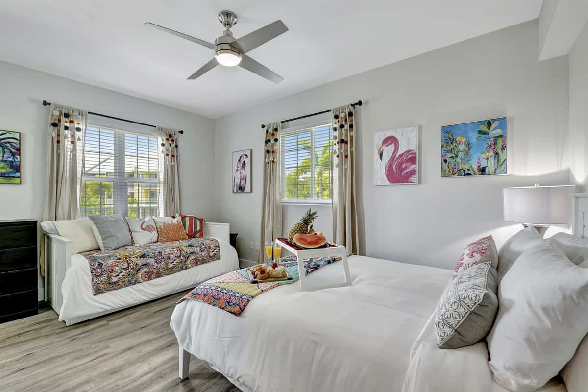 A charmingly decorated bedroom featuring both a queen-size and a twin-size bed.
