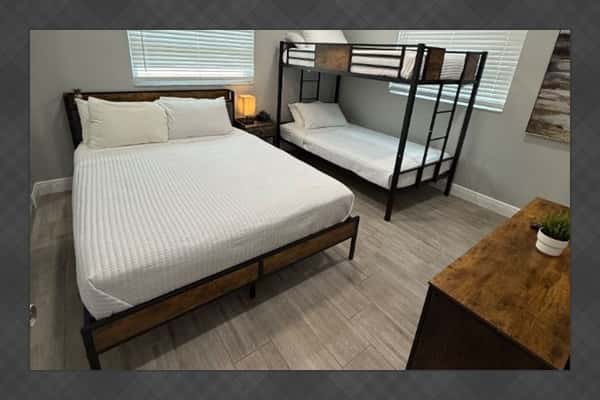 Bedroom 3 offers comfortable sleeping arrangements with a queen-size bed and an additional bunk bed—perfect for families or groups.
