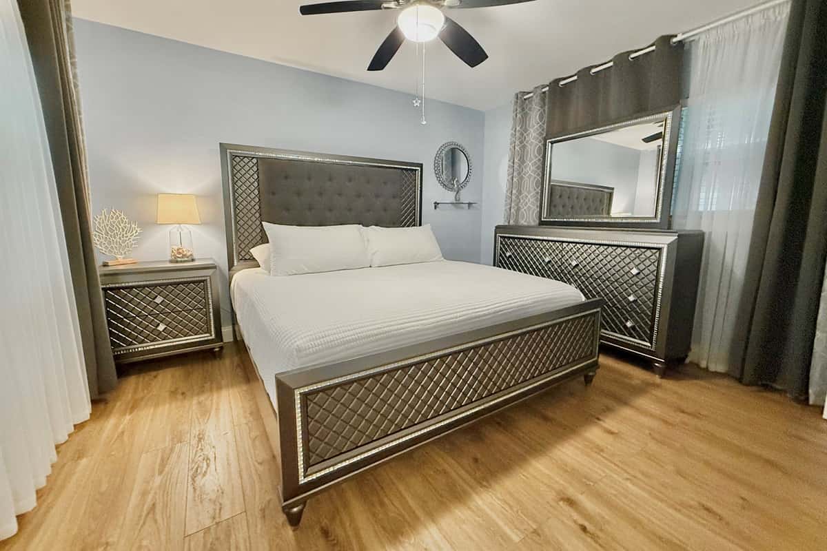 Retreat to a stunning master bedroom featuring a king bed, designer furniture, and calming ambiance—perfect for unwinding in style.