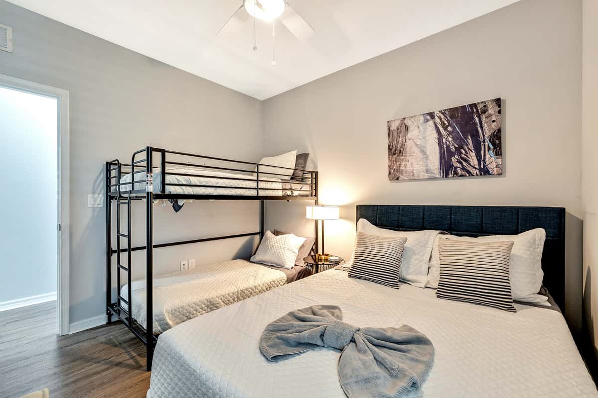 Adding an element of playful charm and practicality, the room features a captivating bunk bed, cleverly designed to accommodate a variety of needs.
