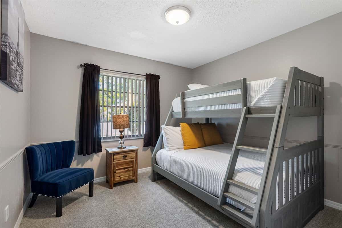 This cozy bedroom features a twin-over-full bunk bed, perfect for accommodating both kids and guests in comfort.