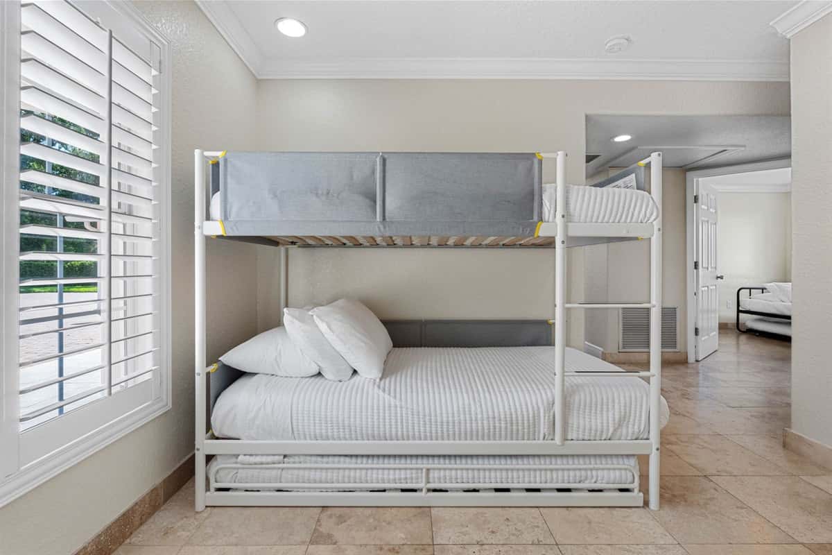 This bedroom is a cheerful and versatile space that’s perfect for children, teens, or additional guests needing a comfortable and convenient place to sleep.