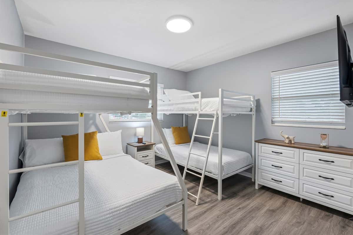 Spacious bunk bedroom featuring two sturdy bunk beds and cozy sleeping spaces.
