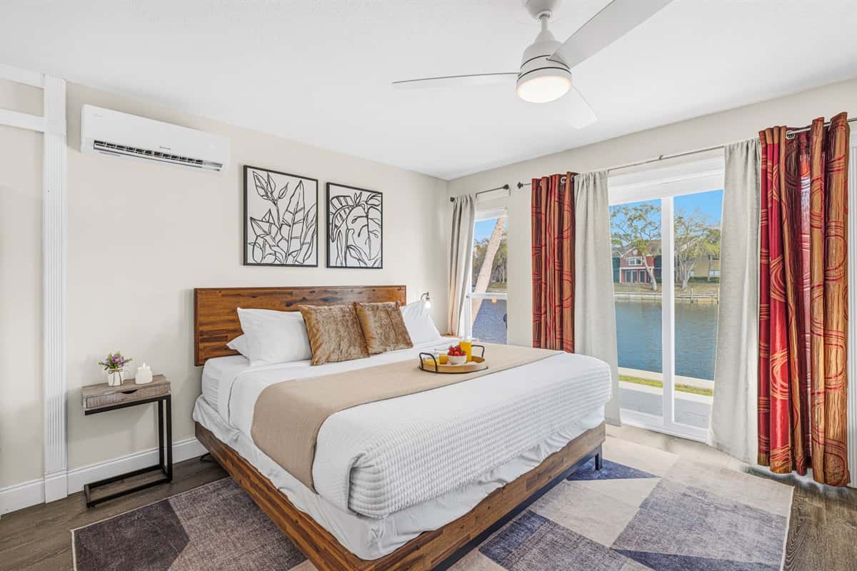 Spacious waterfront bedroom featuring a king bed and beautiful lake views.