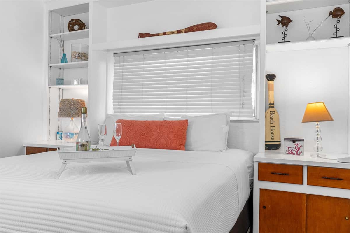 The room features a queen-size bed, perfectly positioned to be the focal point of this serene retreat.