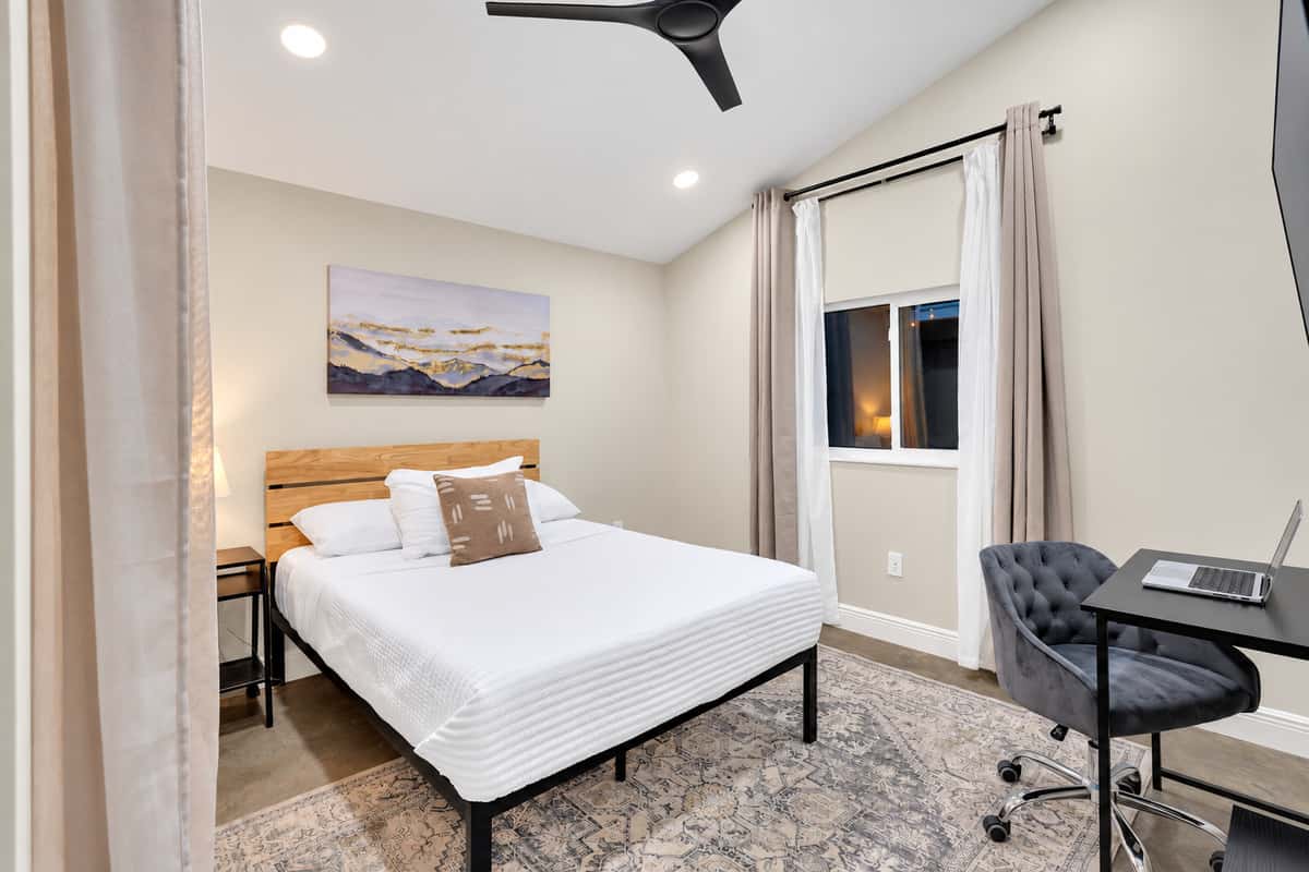 A bedroom with a desk, for the trip you can't fully leave. King-height comfort, a proper work chair and a window with morning light — take the call before nine, then be at the pool by ten.