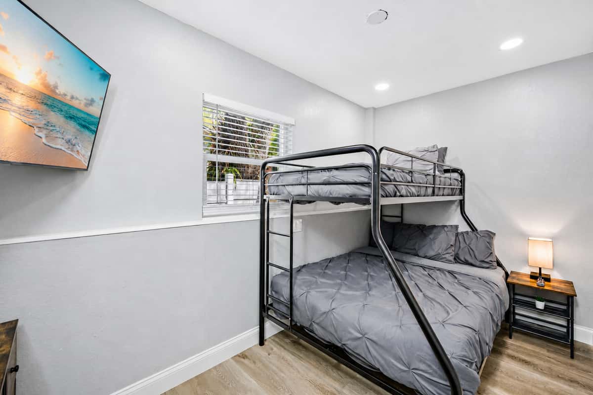This beautiful room has a single over twin bunkbed, drawers for storage, and its own smart TV!