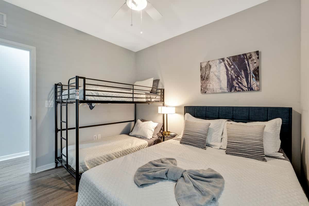 Adding an element of playful charm and practicality, the room features a captivating bunk bed, cleverly designed to accommodate a variety of needs.