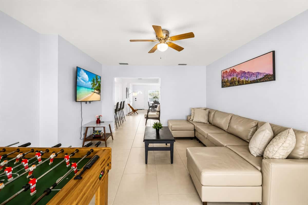 Open living room with foosball table, entertainment space, and cozy sectional seating.