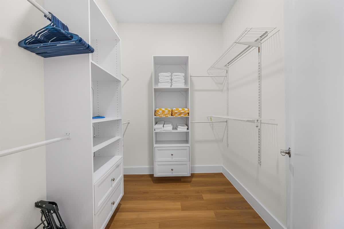 A spacious walk-in closet with hangers and shelving — unpack and make yourself at home.