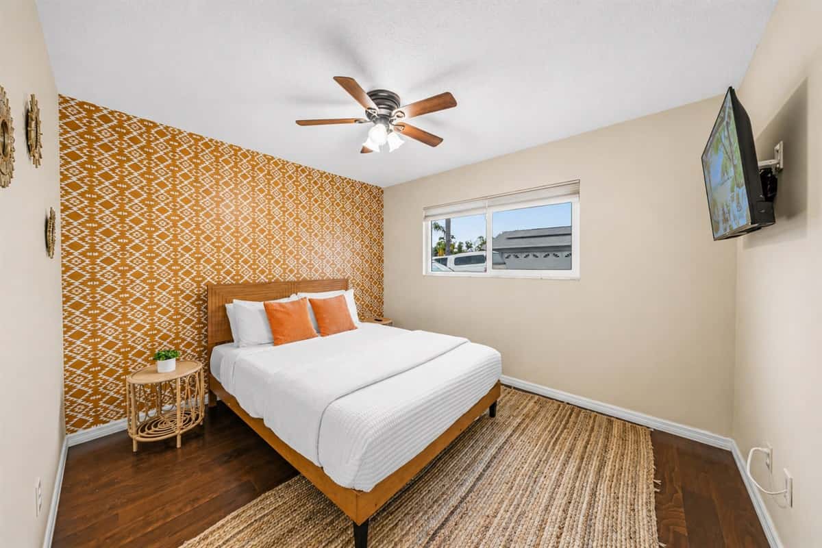 Cozy Bedroom 2 featuring a comfortable king bed, warm tones, and a stylish accent wall.