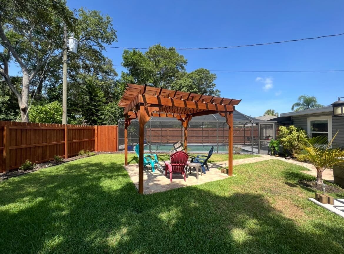 Relax under the charming wooden pergola, perfect for shaded outdoor gatherings.