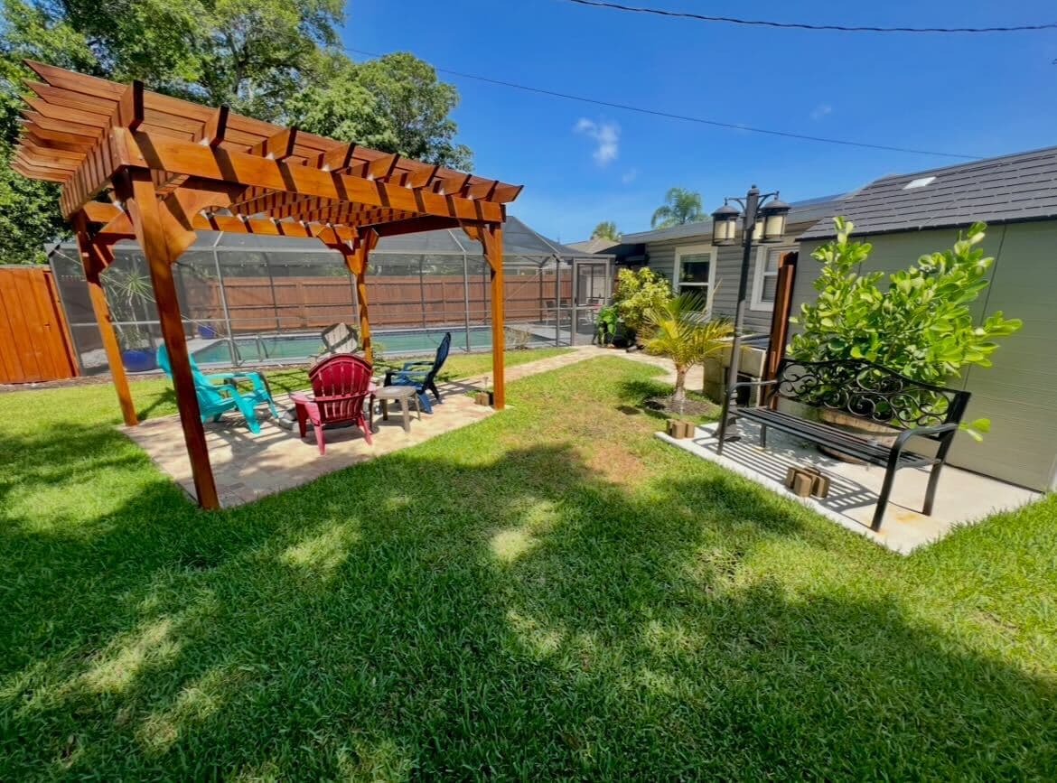 A peaceful outdoor retreat featuring a pergola with comfortable seating.