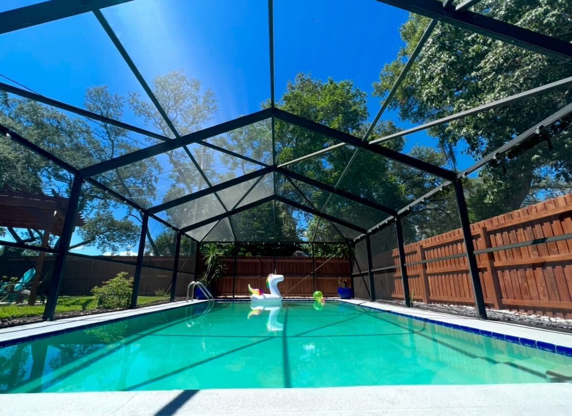 Enjoy a refreshing swim in this private screened-in pool, perfect for sunny Florida days.