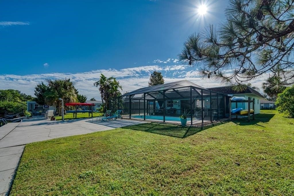 Imagine stepping into the backyard of a beautiful house nestled near the tranquil water canal.