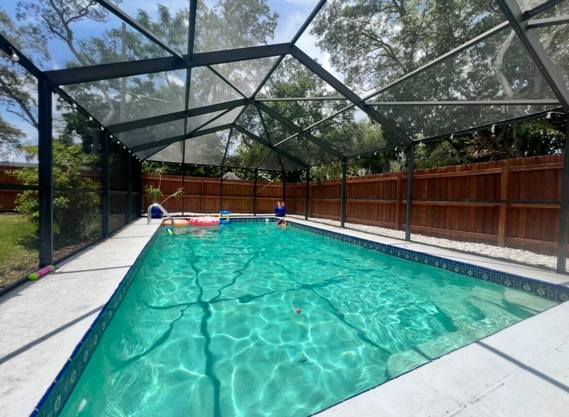 A bright and open screened pool, perfect for relaxing or playing.