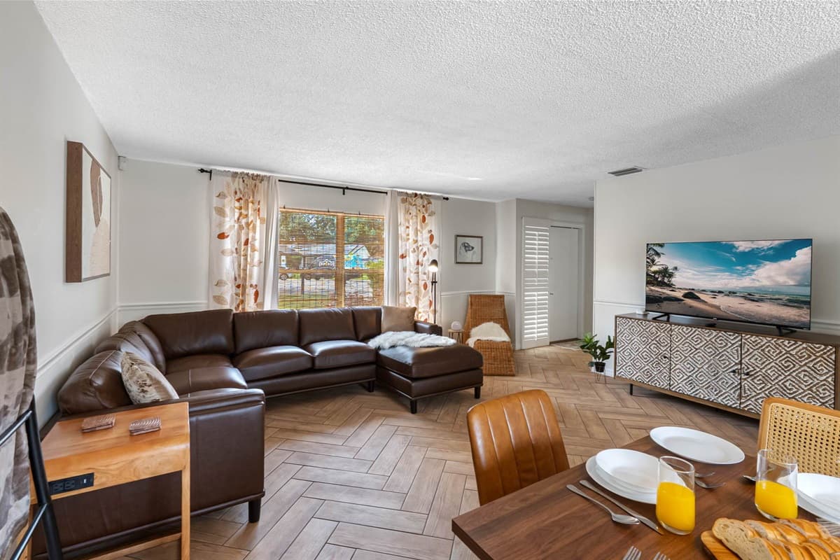 With its spacious layout and inviting design, this living room is perfect for movie nights, game days, or quiet mornings with coffee. The smart TV and plush seating create an ideal entertainment zone.