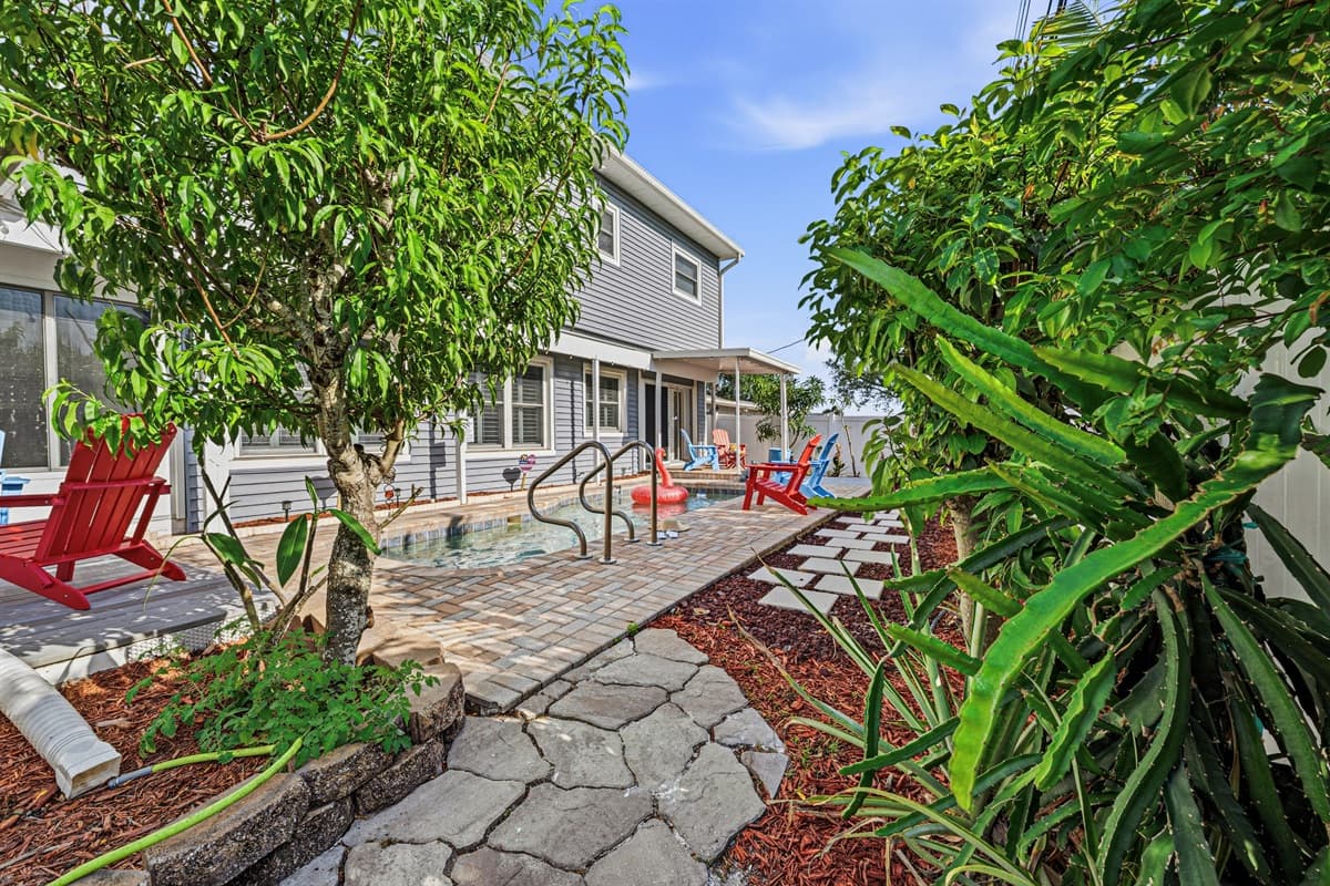 Lush landscaping and stone pathway surrounding the home—enhancing the outdoor experience 