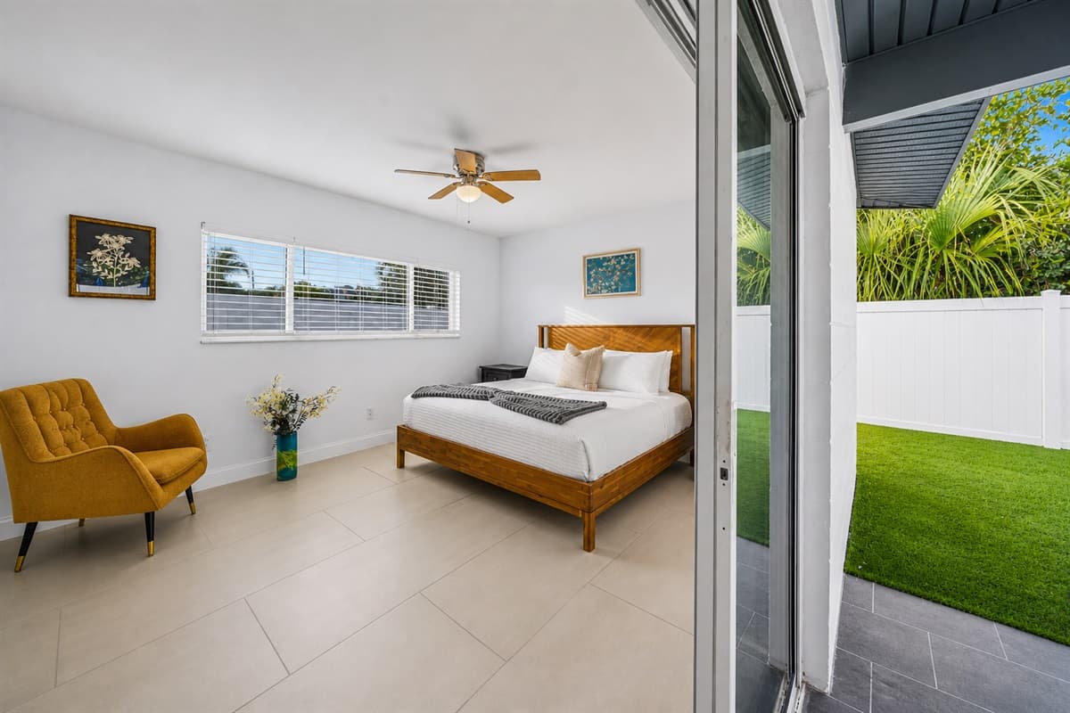 Bedroom with direct patio access, natural light, and relaxing indoor-outdoor feel.