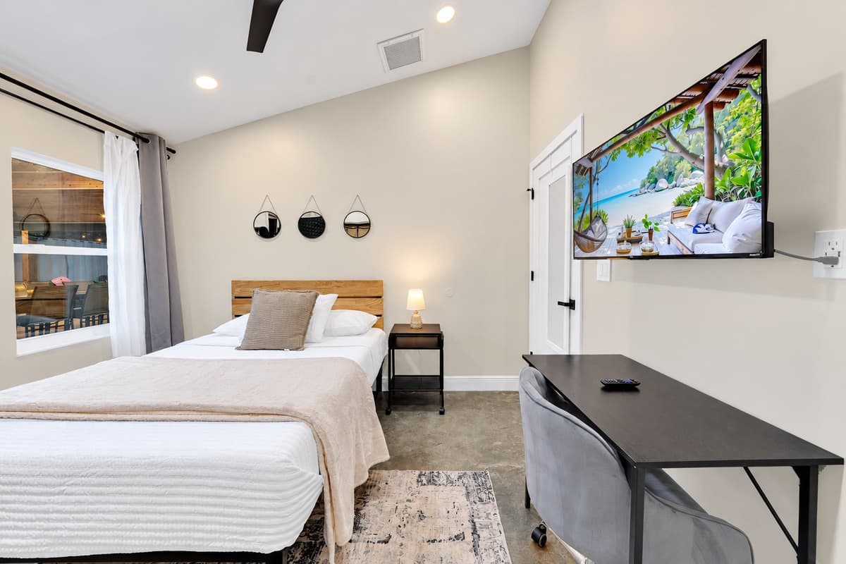 A bedroom with a real desk, not a side table. Take the morning call, close the laptop by nine, and be in the pool before anyone in the group has noticed you were working at all.