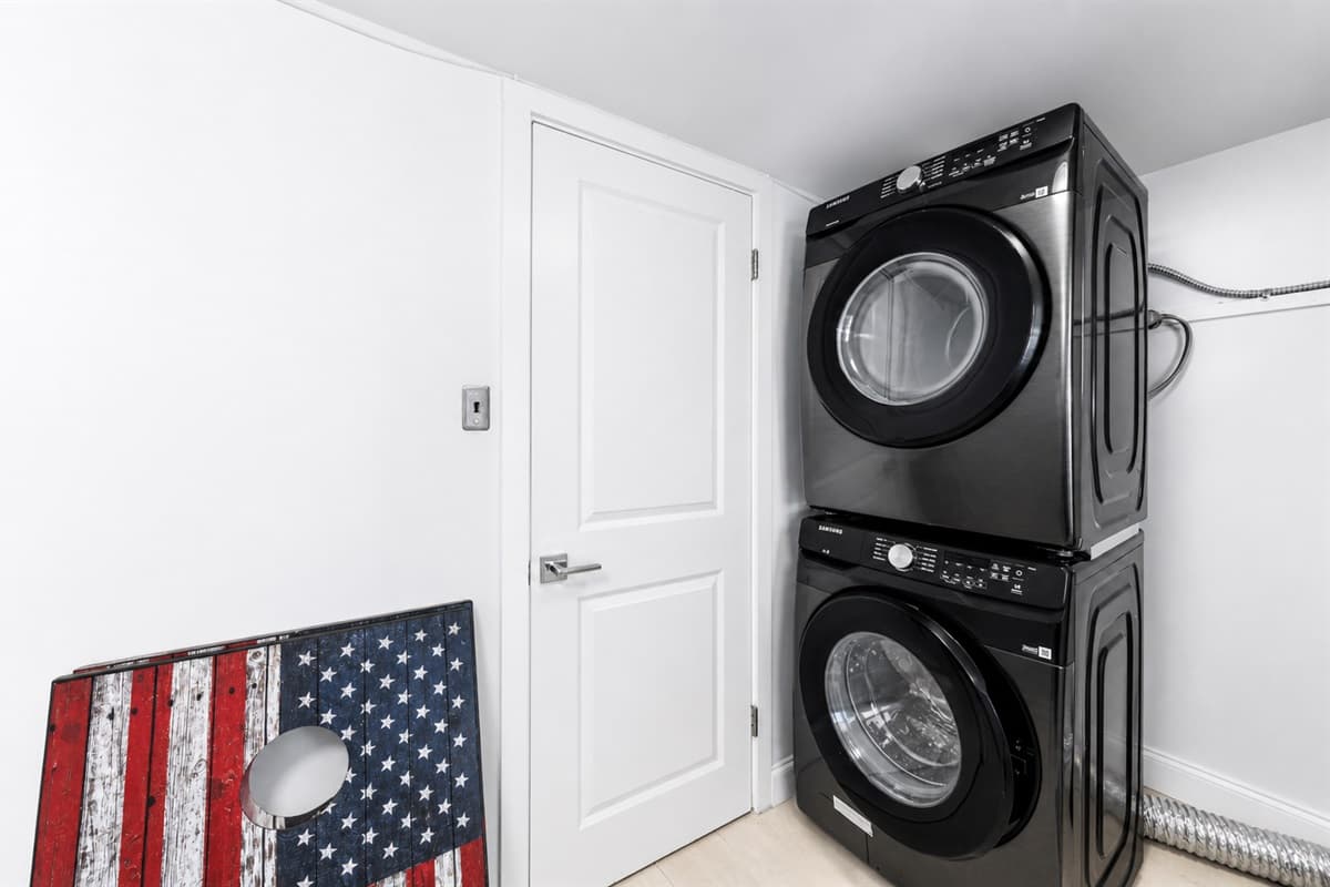 Convenient in-home laundry area featuring stacked washer and dryer for guest use.

