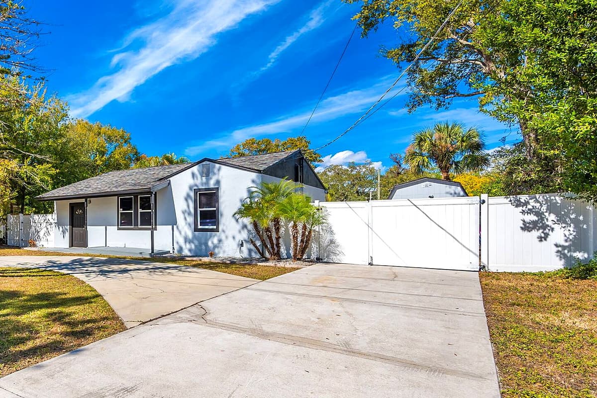 Stunning front view of the house showcasing the front yard and parking area that is equipped with CCTV cameras to ensure your safety during your stay. Send us a message if you have any questions!